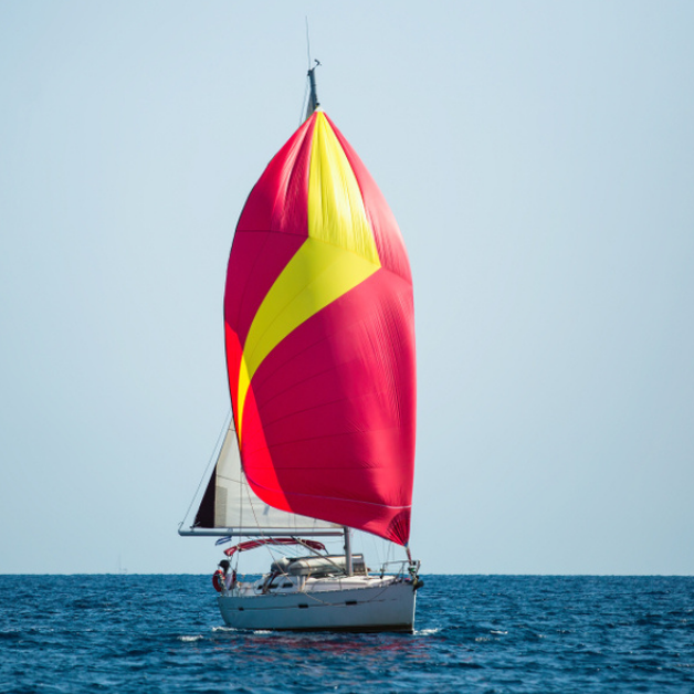 Why is it worth renting a gennaker with your charter boat and what does it offer compared to conventional sails?