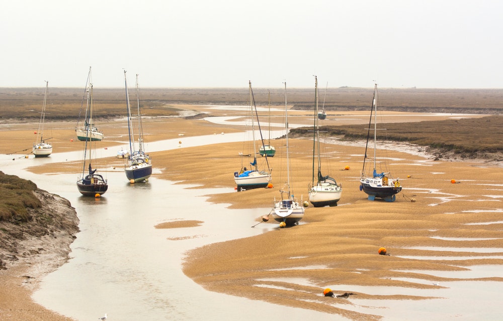 Sailing boats on land after low tide