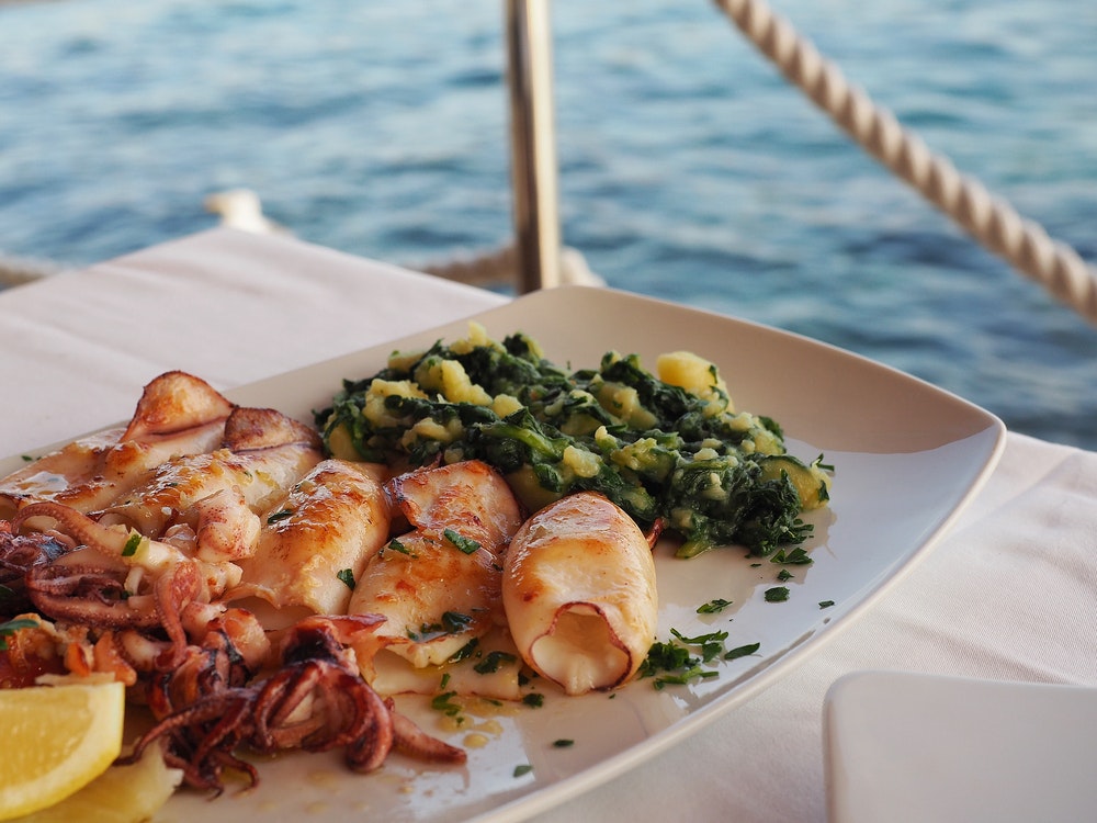 Also traditional Croatian grilled squid served on a plate.