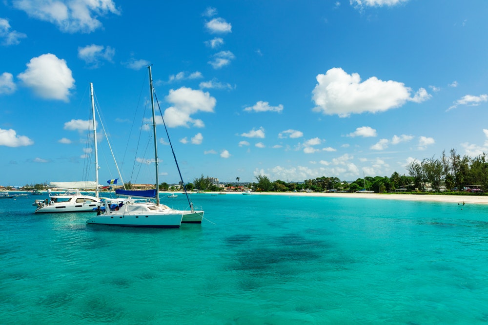 Slunný tropický karibský ostrov Barbados s modrou vodou a katamarány