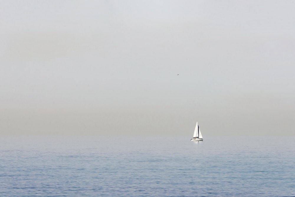 Sailboat in a haze on the open sea