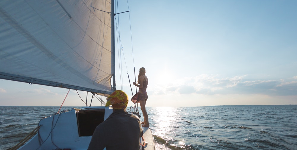 Couple on board a sailing boat, romantic sea view.