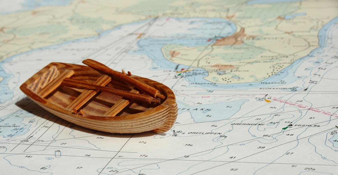 Wooden boat on the ocean map