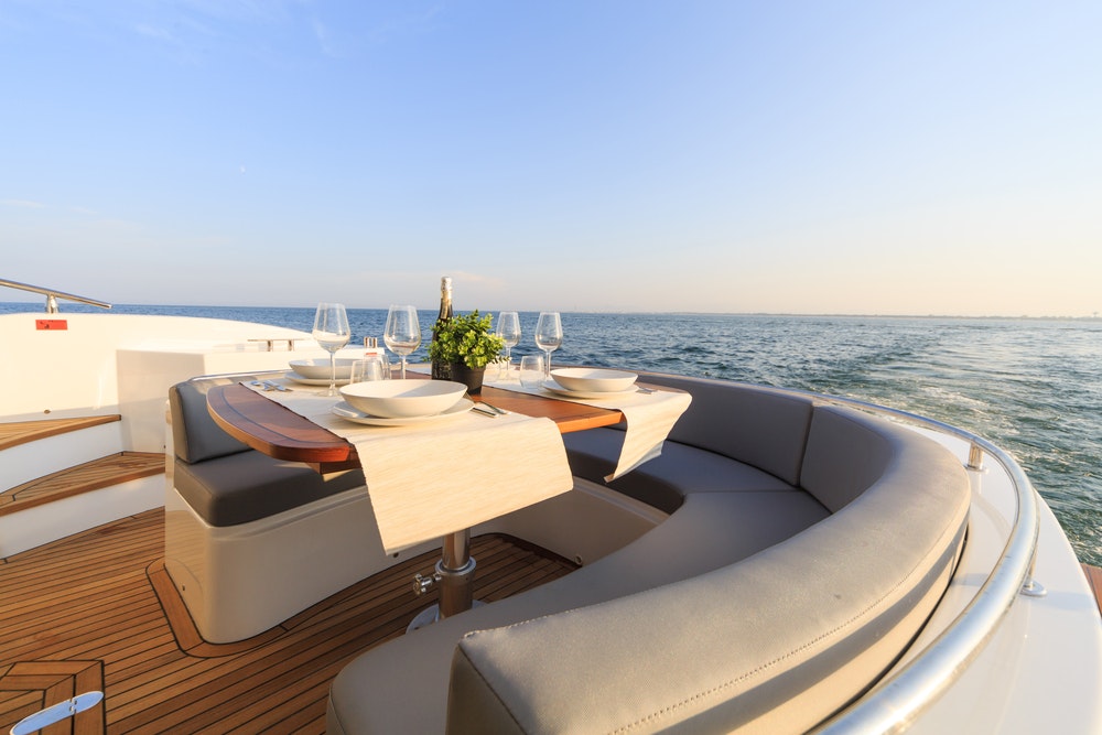 romantic lunch on a motor yacht at sunset,