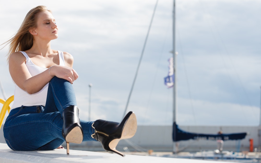 Woman in a marina with high heels.