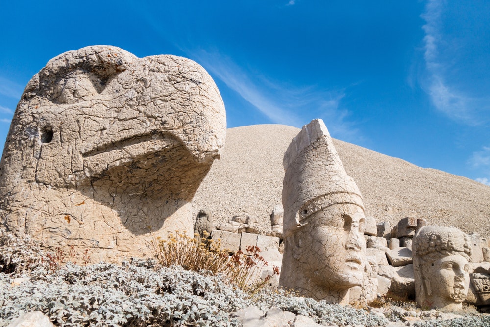 Stone heads of the eagle, King Antiochus and the goddess Tyche on the famous Mount Nemrut, Kahta, Turkey. The burial complex was built in 65 BC. 