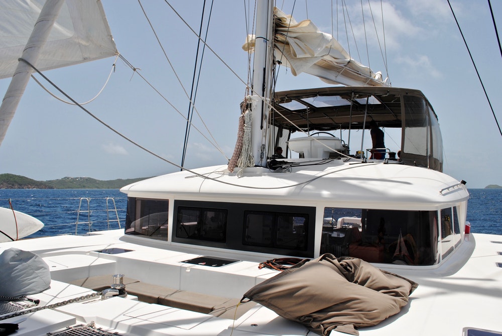 Exterior view of the catamaran's foredeck, cabin and bridge on a sunny day