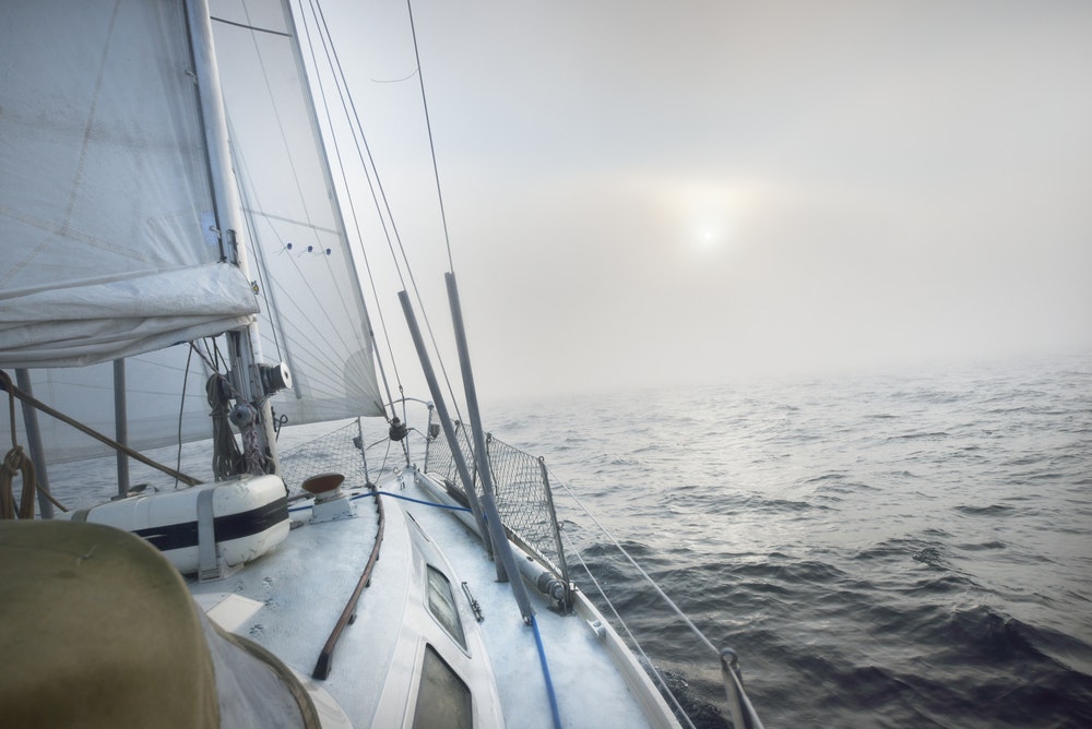 Sailing boat in light fog