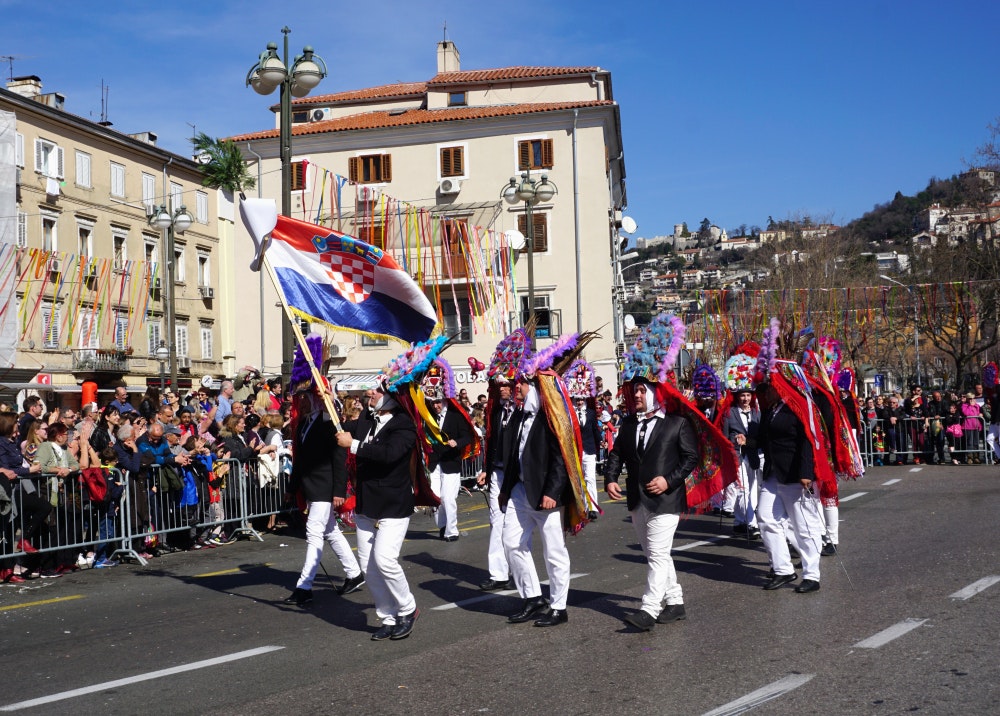 Rijeka, Croatia, Group of men masked in traditional costume at a carnival parade