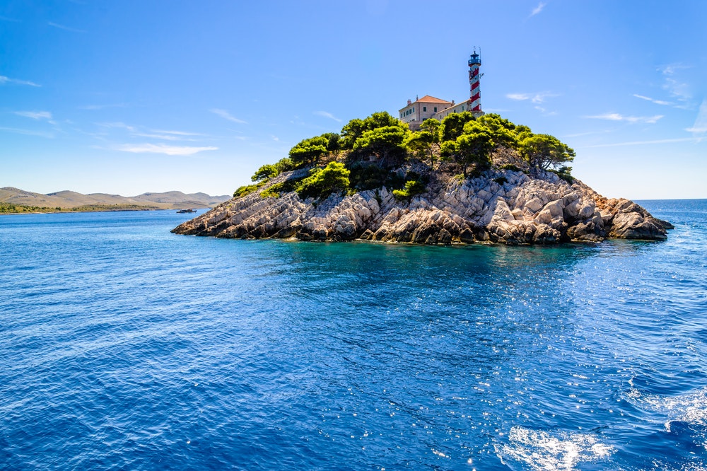 Chorvatský skalnatý ostrov s majákem na Vela Sestrica u Kornatů, Jaderské moře, Chorvatsko,