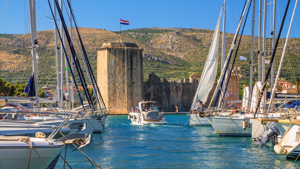 Summer landscape on the coast - view of the harbour and Kamerlengo Castle in Trogir on the Adriatic coast of Croatia